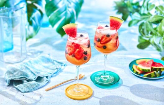 Lemonade iced tea sangria with fresh berries and watermelon.